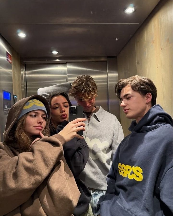 Friends taking a selfie in an elevator, before