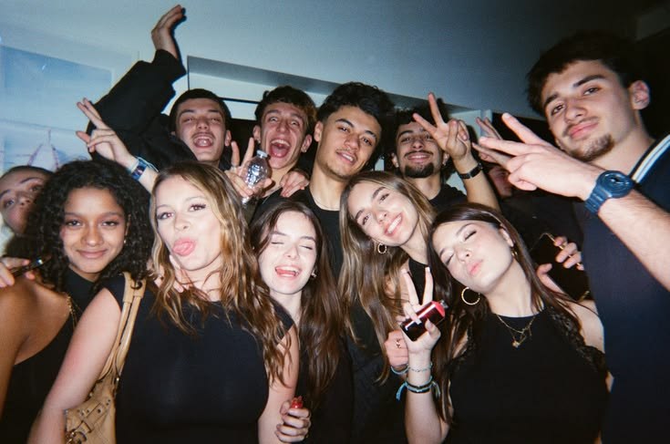 A group of friends posing for a flash photo at a party